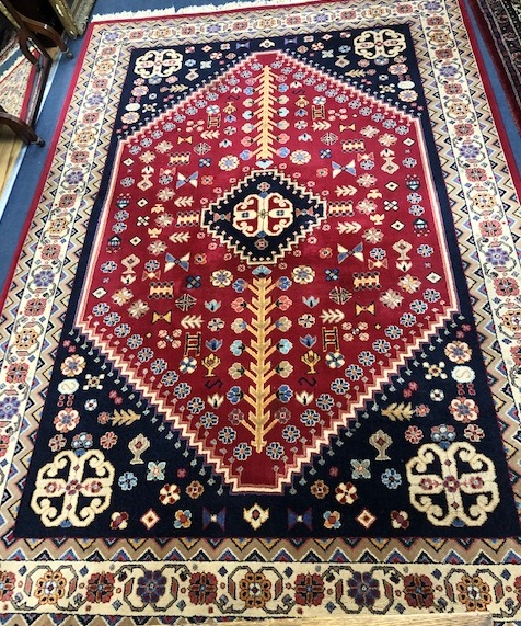A Persian blue and red medallion rug 300 x 200cm